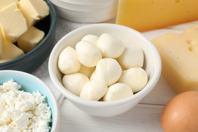 Photo of Different dairy products on white wooden table, closeup
