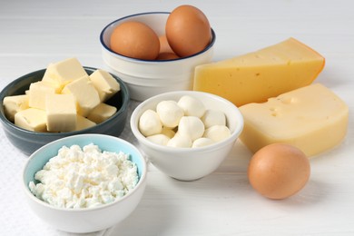Photo of Different dairy products and eggs on white wooden table, closeup