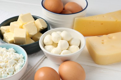 Photo of Different dairy products and eggs on white wooden table, closeup