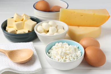 Photo of Different dairy products and eggs on white wooden table, closeup