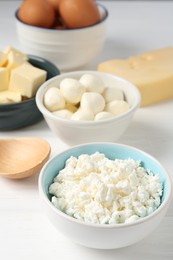Photo of Different dairy products and eggs on white wooden table, closeup