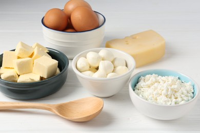 Photo of Different dairy products and eggs on white wooden table, closeup