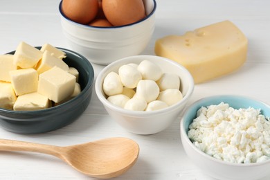 Photo of Different dairy products and eggs on white wooden table, closeup