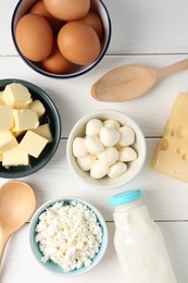 Photo of Different dairy products and eggs on white wooden table, flat lay