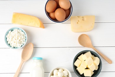 Photo of Frame of different dairy products and eggs on white wooden table, flat lay. Space for text