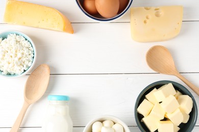 Photo of Frame of different dairy products and eggs on white wooden table, flat lay. Space for text