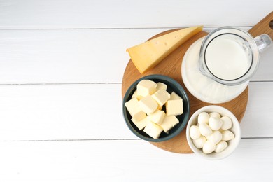 Photo of Different dairy products on white wooden table, top view. Space for text