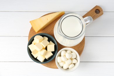 Photo of Different dairy products on white wooden table, top view
