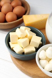 Photo of Different dairy products and eggs on white wooden table, closeup