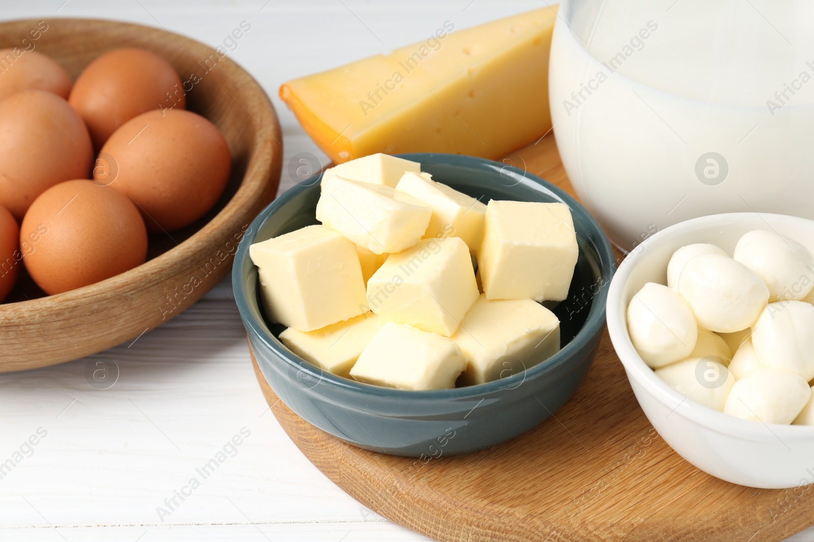 Photo of Different dairy products and eggs on white wooden table, closeup