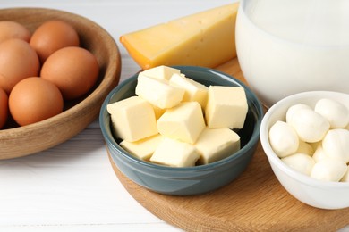 Photo of Different dairy products and eggs on white wooden table, closeup