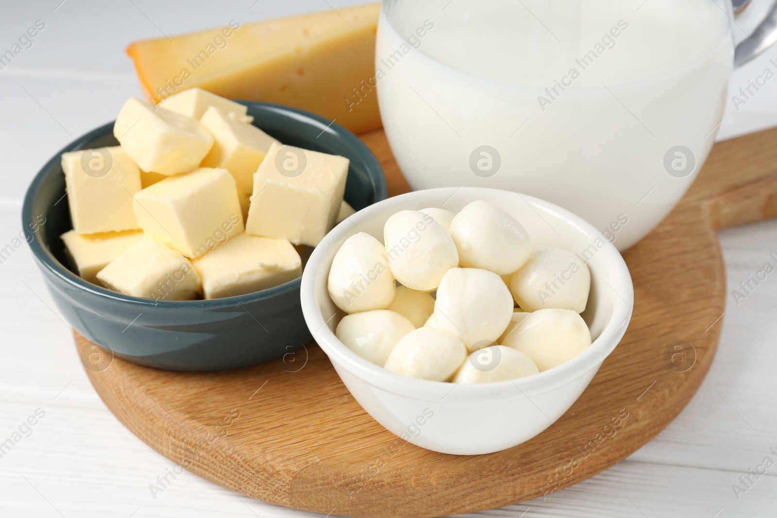 Photo of Different dairy products on white wooden table, closeup