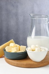 Photo of Different dairy products on white wooden table