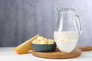 Photo of Different dairy products on white wooden table