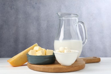 Photo of Different dairy products on white wooden table