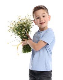Photo of Smiling little boy with bouquet of beautiful chamomile flowers on white background