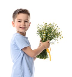 Photo of Smiling little boy with bouquet of beautiful chamomile flowers on white background