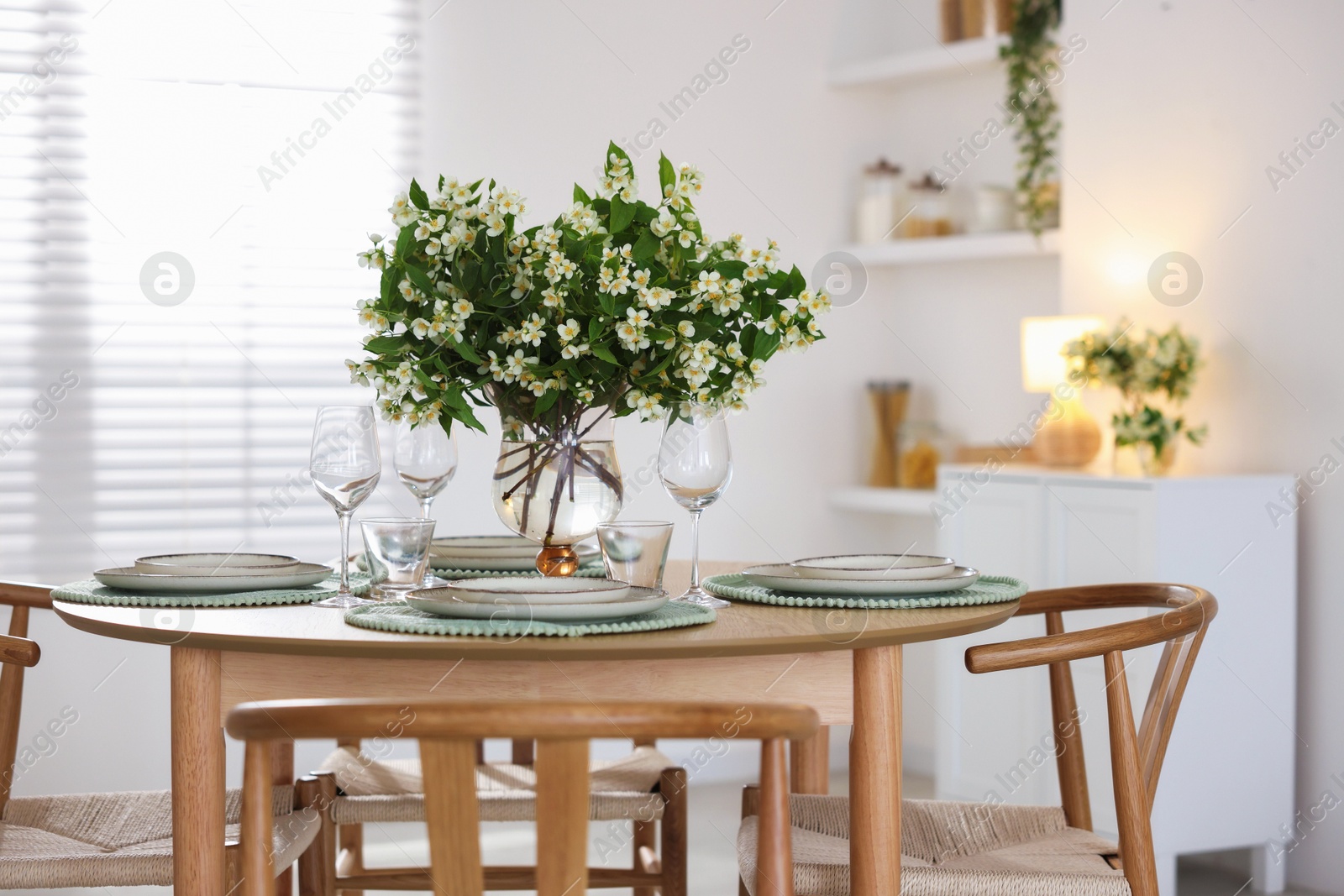 Bouquet of beautiful jasmine flowers on dining table indoors Photo of Bouquet of beautiful jasmine flowers on dining table indoors