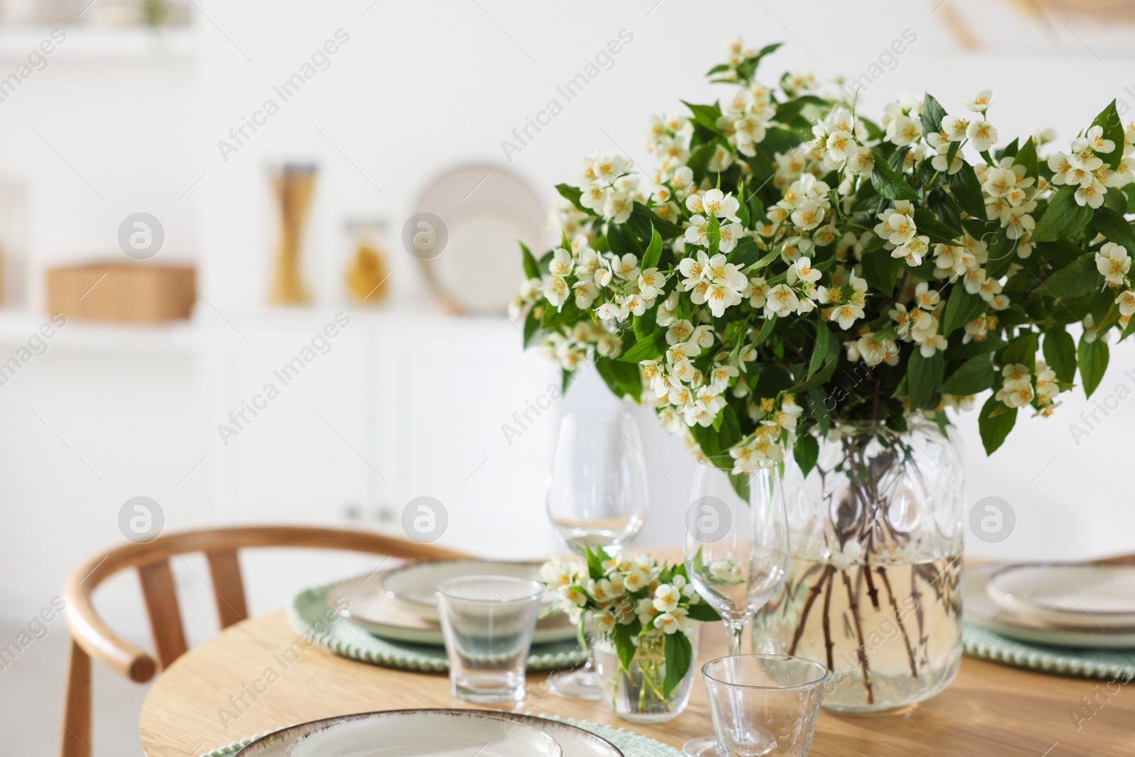 Bouquet of beautiful jasmine flowers on dining table indoors. Space for text Photo of Bouquet of beautiful jasmine flowers on dining table indoors. Space for text