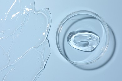 Photo of Cosmetic product in Petri dish on light blue background, top view