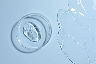 Photo of Cosmetic product in Petri dish on light blue background, top view