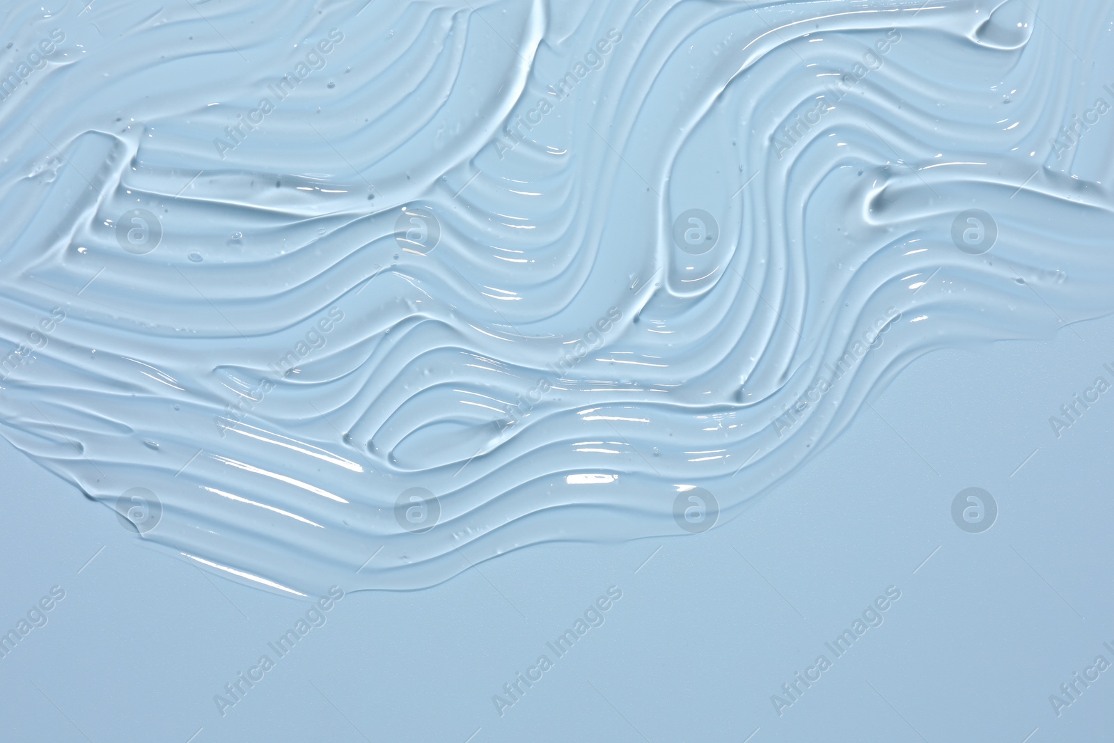 Sample of cosmetic product on light blue background, closeup Photo of Sample of cosmetic product on light blue background, closeup
