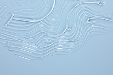 Photo of Sample of cosmetic product on light blue background, closeup