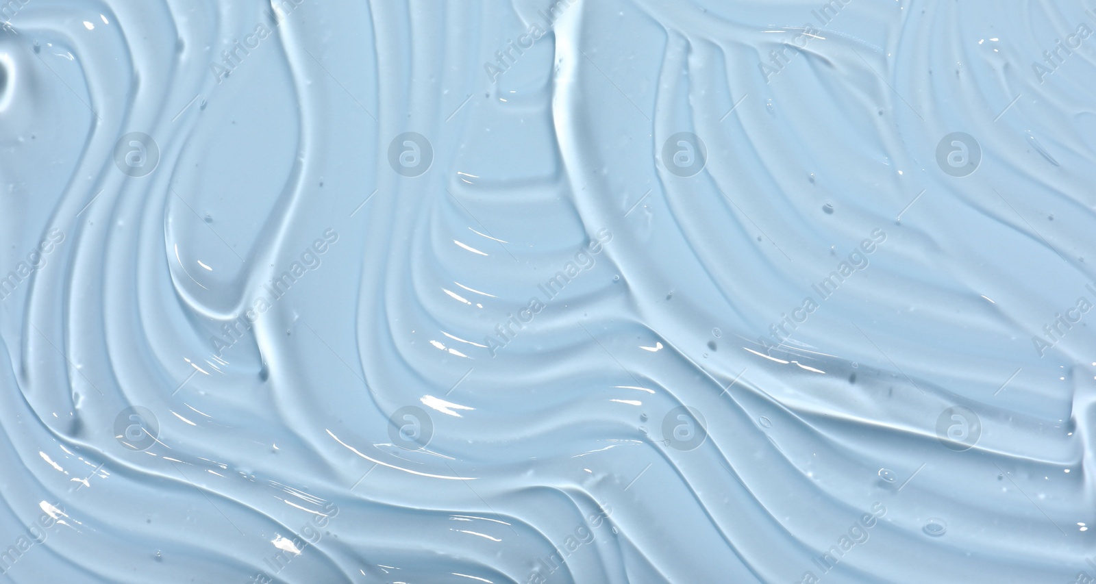 Sample of cosmetic product on light blue background, closeup Photo of Sample of cosmetic product on light blue background, closeup