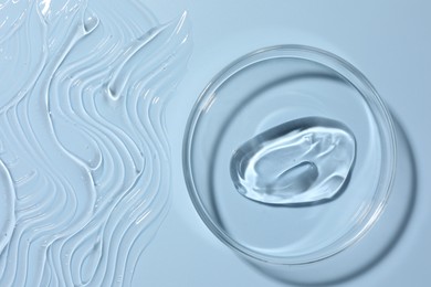 Photo of Cosmetic product in Petri dish on light blue background, top view