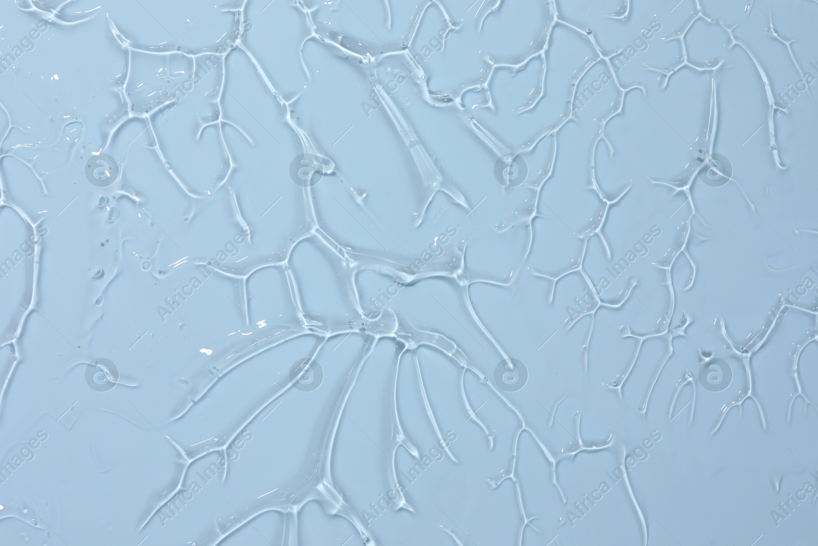 Sample of cosmetic product on light blue background, closeup Photo of Sample of cosmetic product on light blue background, closeup