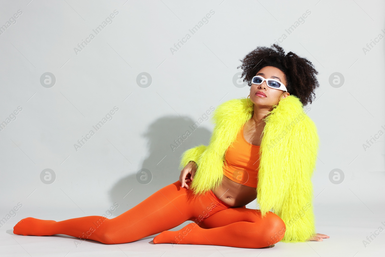 Photo of Fashionable portrait of beautiful Brazilian woman in stylish outfit on white background
