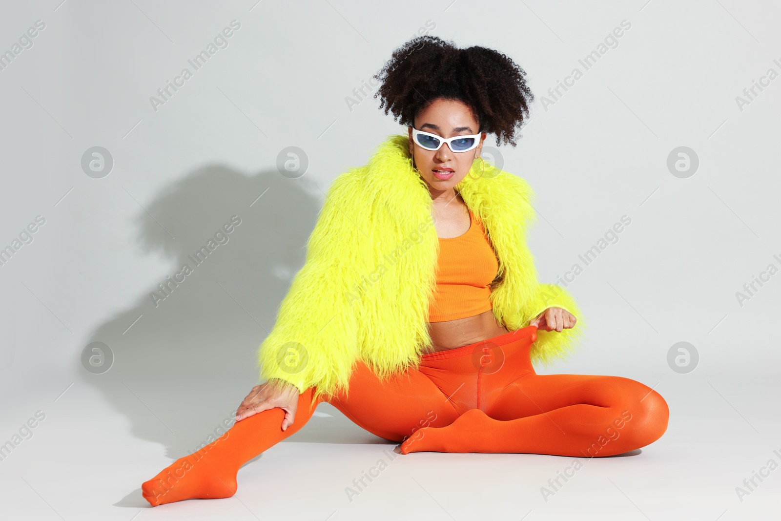 Photo of Fashionable portrait of beautiful Brazilian woman in stylish outfit on white background