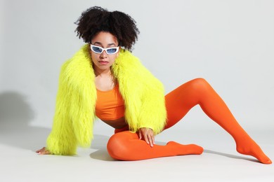 Photo of Fashionable portrait of beautiful Brazilian woman in stylish outfit on white background