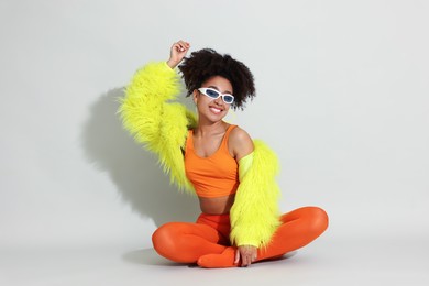 Photo of Fashionable portrait of beautiful Brazilian woman in stylish outfit on white background