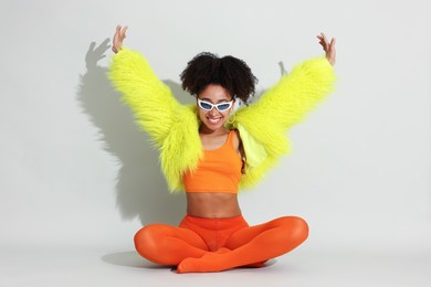 Photo of Fashionable portrait of beautiful Brazilian woman in stylish outfit on white background