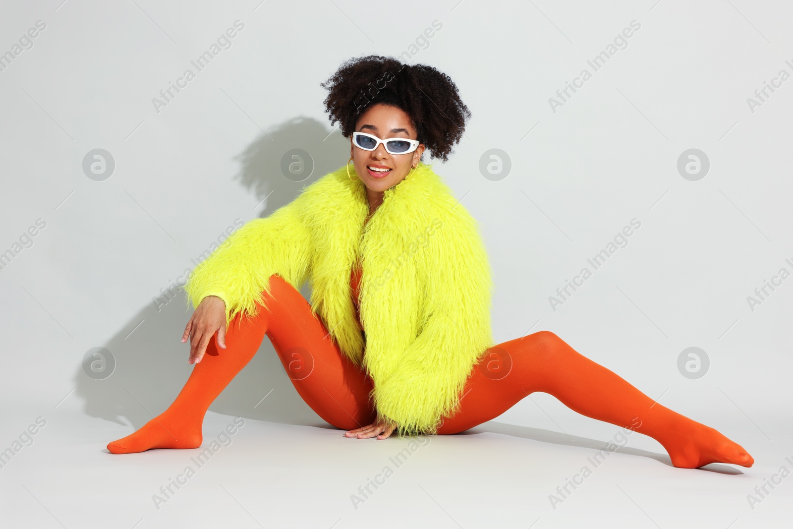 Photo of Fashionable portrait of beautiful Brazilian woman in stylish outfit on white background