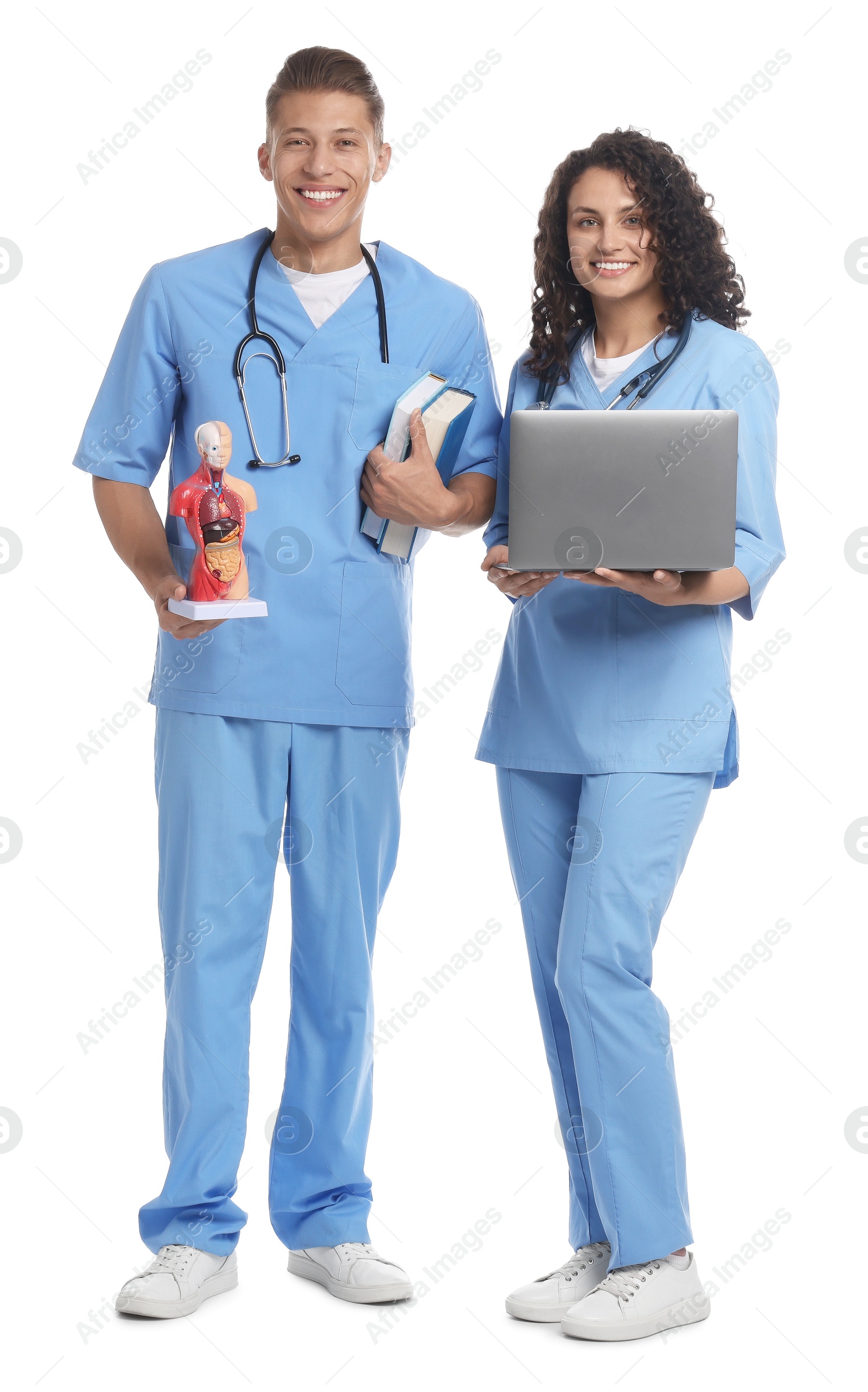 Photo of Medical students with laptop and human body model on white background