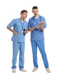 Photo of Medical students with tablet and book on white background