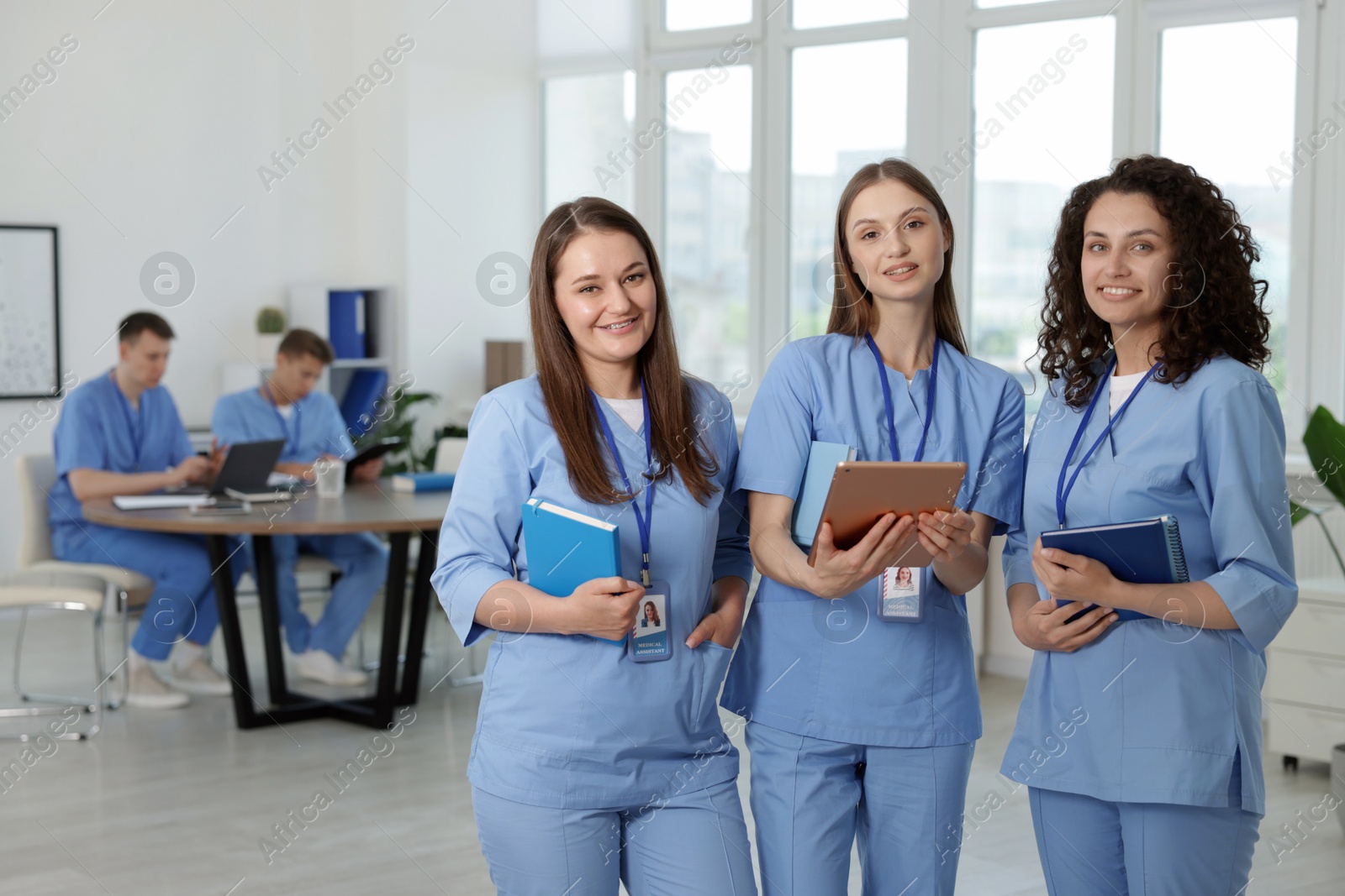 Photo of Medical students in uniforms indoors, selective focus