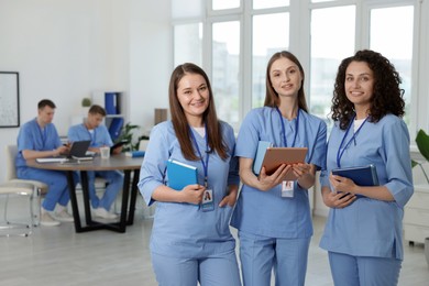 Photo of Medical students in uniforms indoors, selective focus