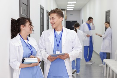 Photo of Medical students in uniforms indoors, selective focus