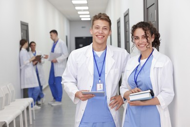 Photo of Medical students in uniforms indoors, selective focus