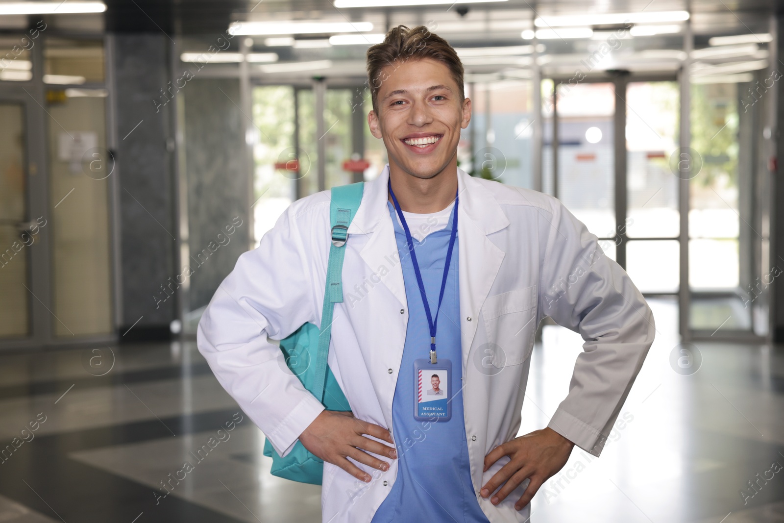 Photo of Medical student in uniform with backpack indoors