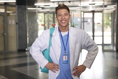 Photo of Medical student in uniform with backpack indoors
