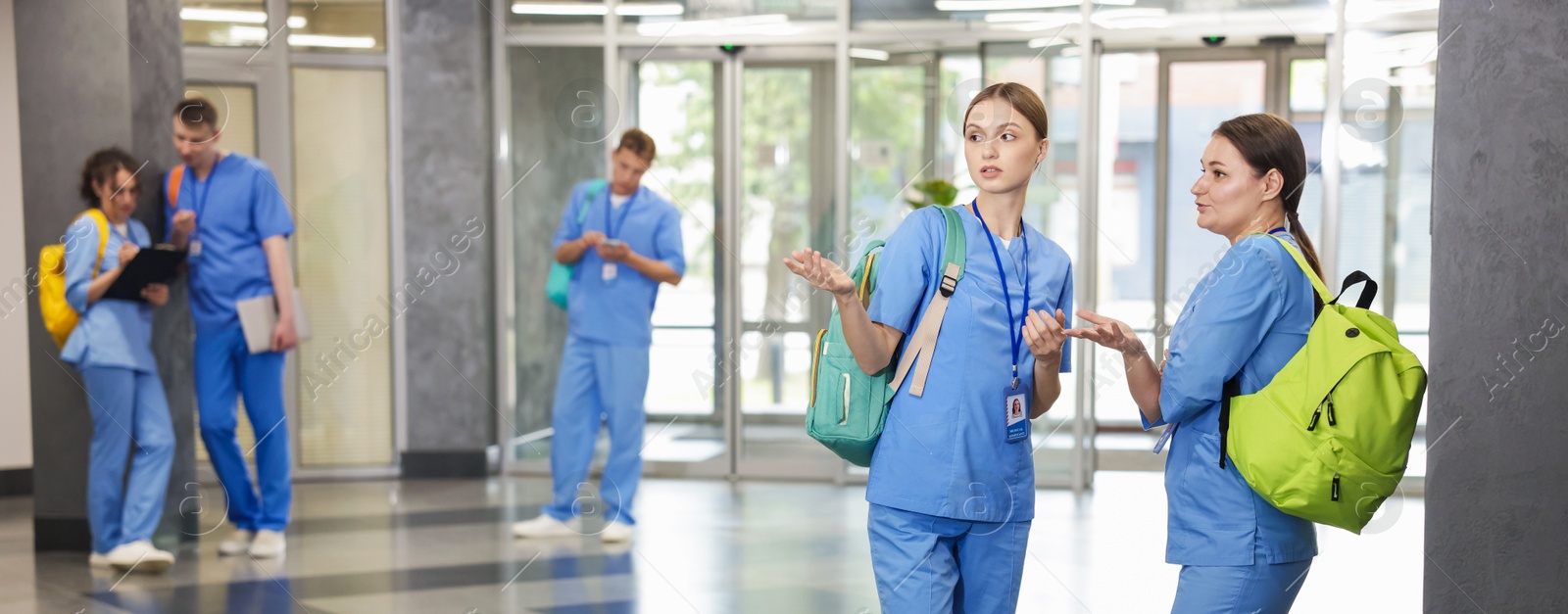 Photo of Medical students in uniforms indoors, selective focus