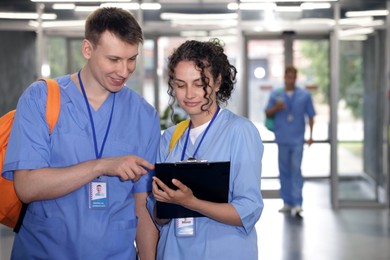 Photo of Medical students in uniforms indoors, selective focus