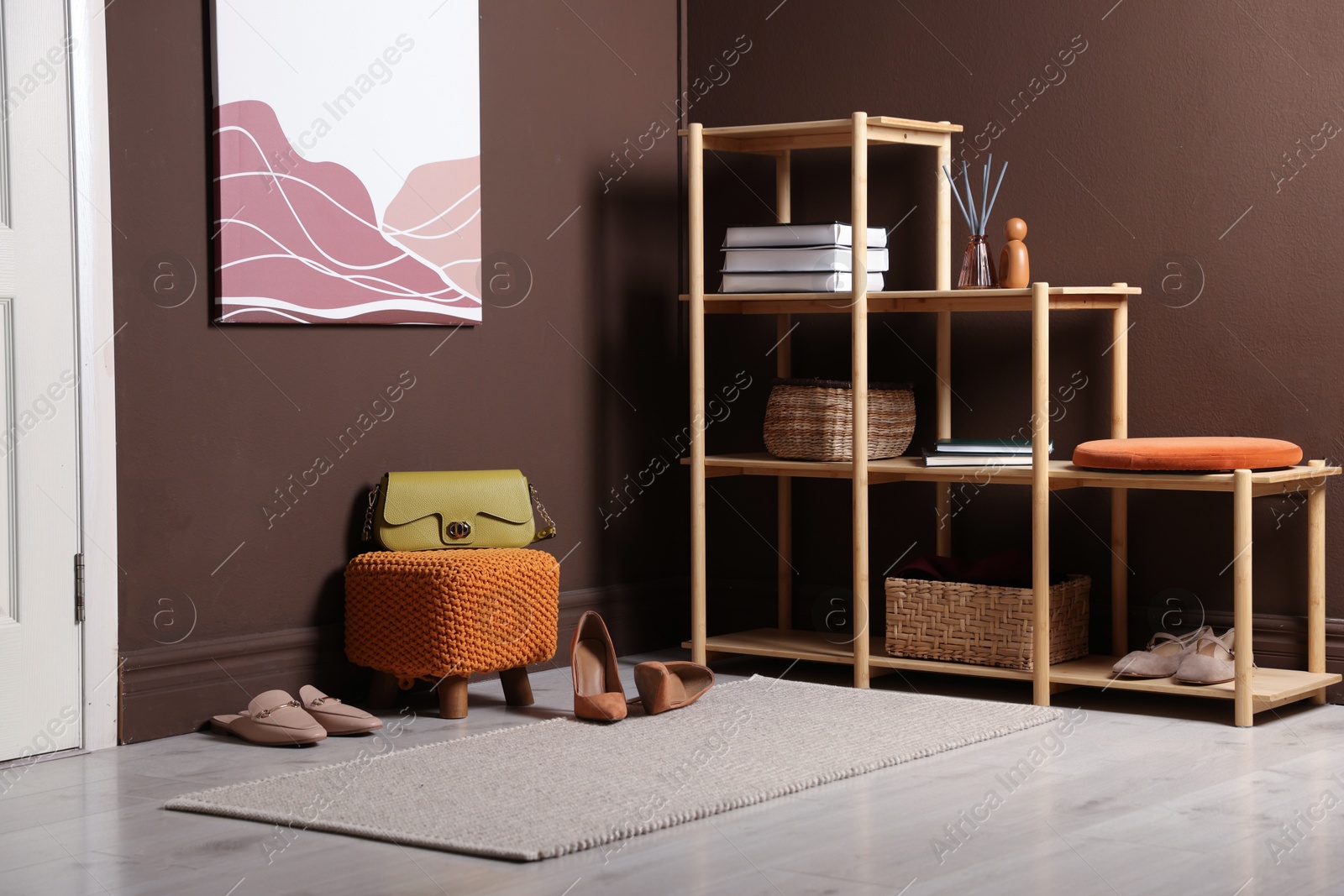 Stylish pouf with bag and shoes at home Photo of Stylish pouf with bag and shoes at home