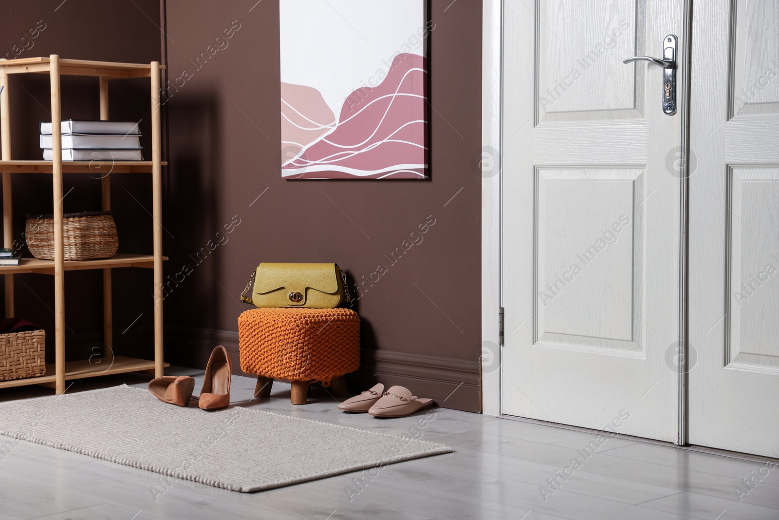 Stylish pouf with bag and shoes at home Photo of Stylish pouf with bag and shoes at home