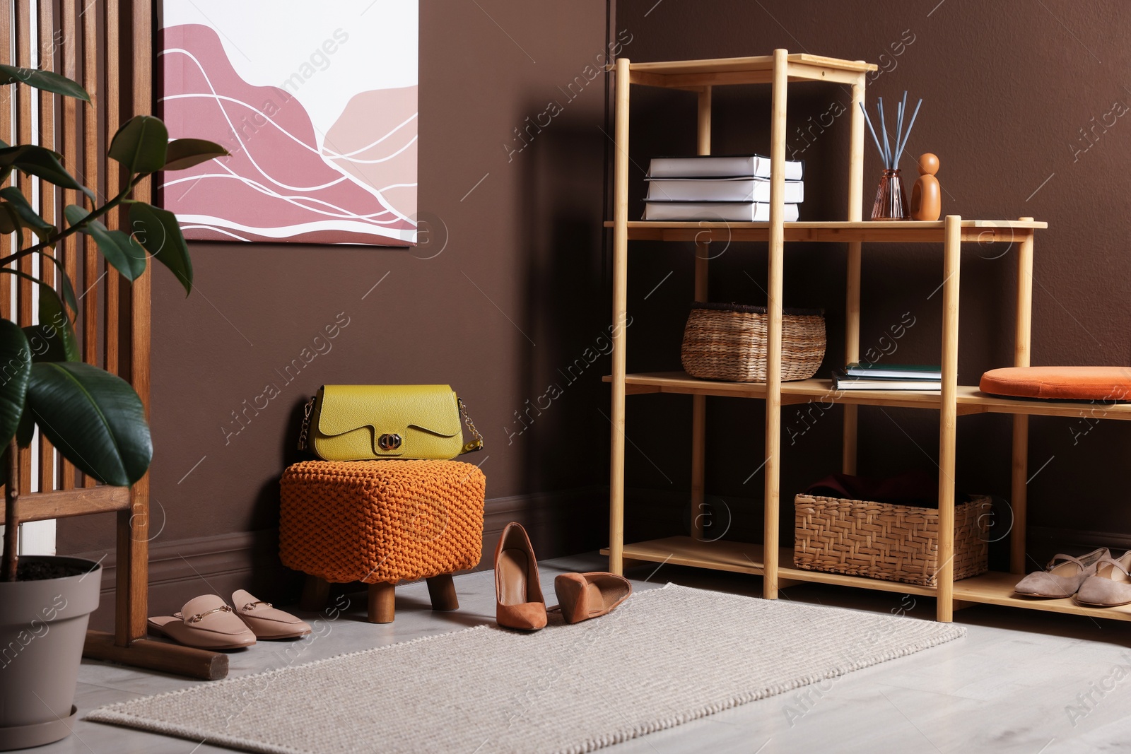 Stylish pouf with bag and shoes at home Photo of Stylish pouf with bag and shoes at home