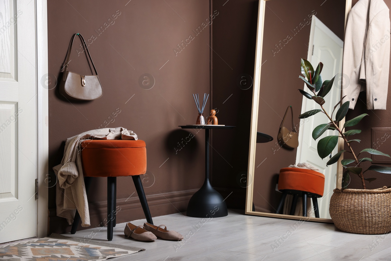 Stylish pouf with shirt and shoes at home Photo of Stylish pouf with shirt and shoes at home